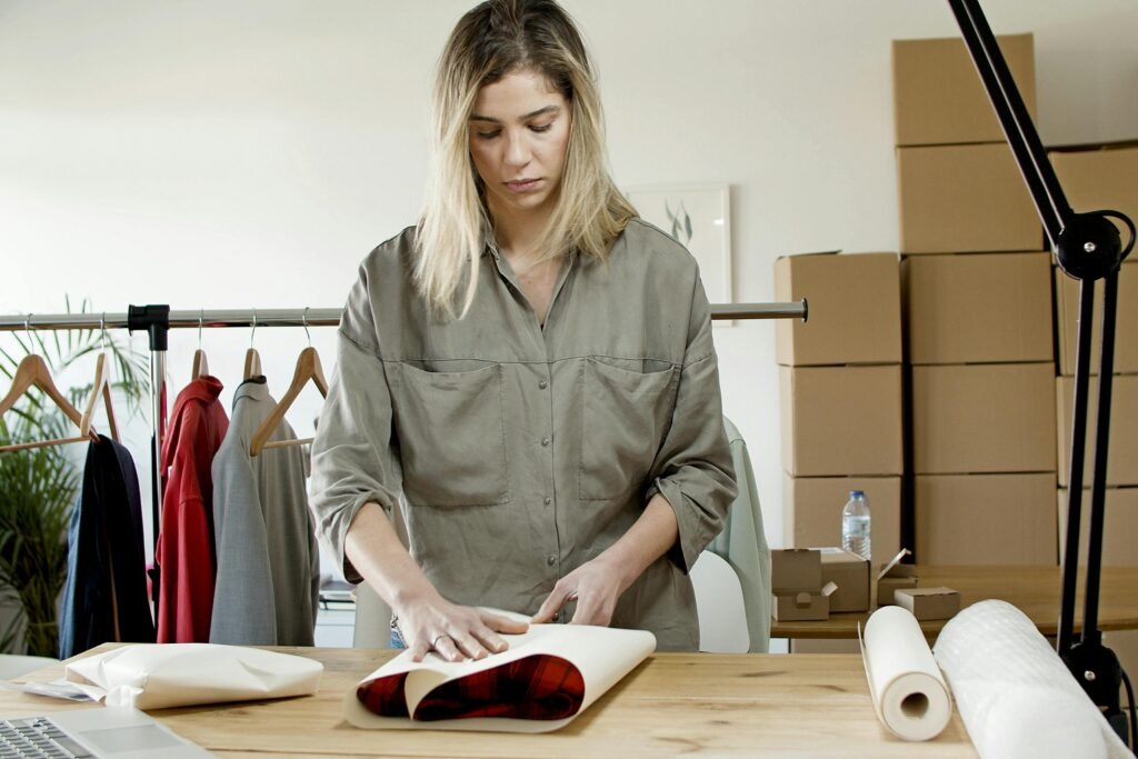 Woman in Gray Dress Shirt Wrapping the Plaid Shirt